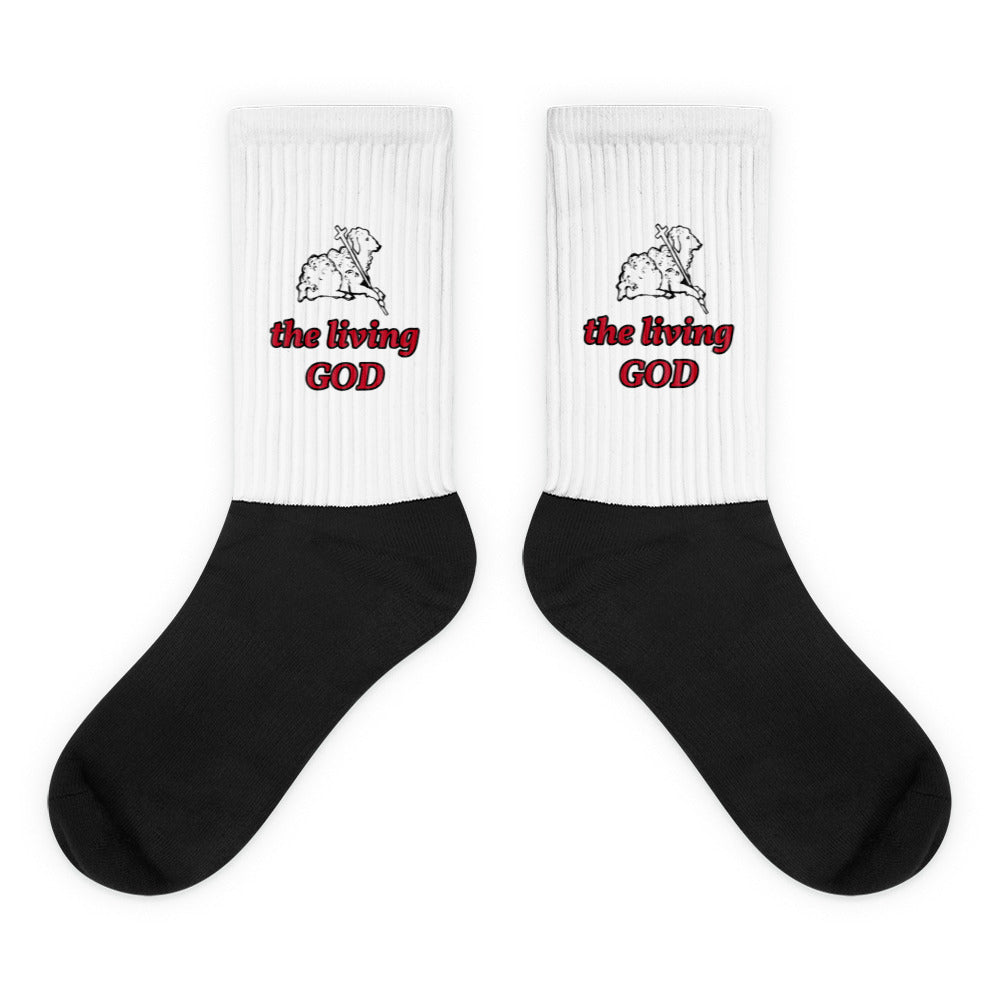 Black and white Christian socks with Lamb of God graphic and “the living GOD” text in red and black.