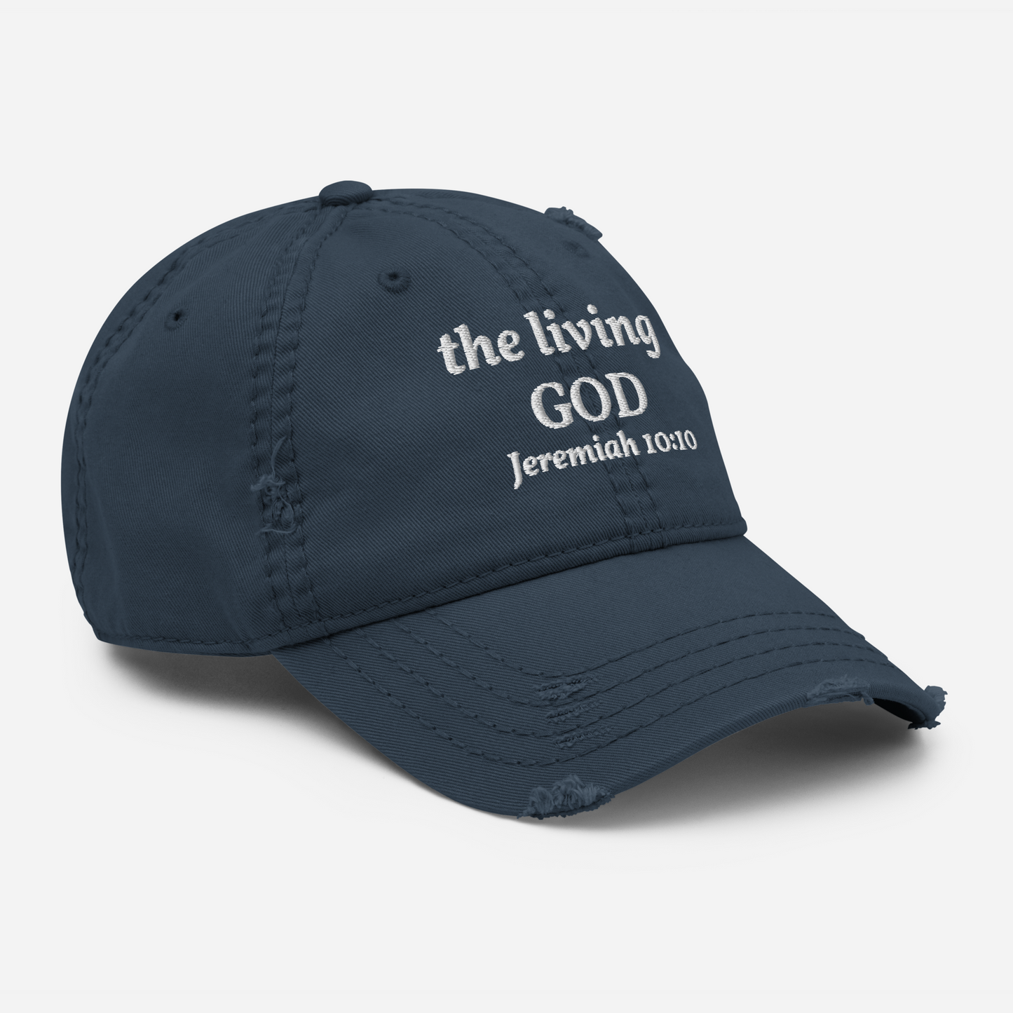 The Kingdom Mindset Dad Hat by My Store is a navy blue cotton cap with distressed details and white the living GOD Jeremiah 10:10 embroidery—an adjustable, stylish way to express your faith.