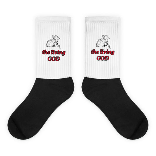 Black and white Christian socks with Lamb of God graphic and “the living GOD” text in red and black.